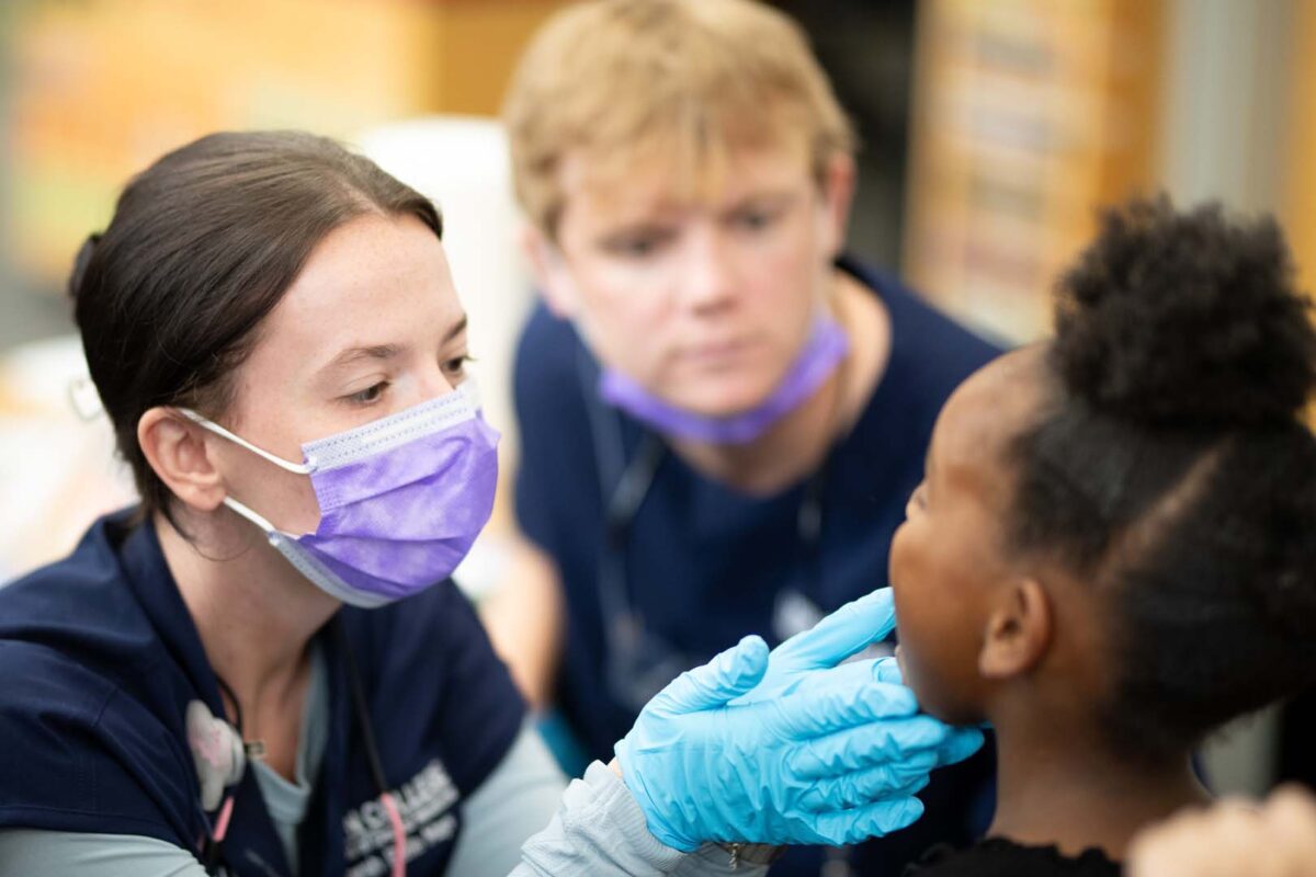 Lyon college Dental Students inspecting teeth
